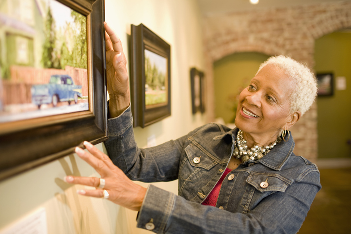 female looking at a painting in art museum